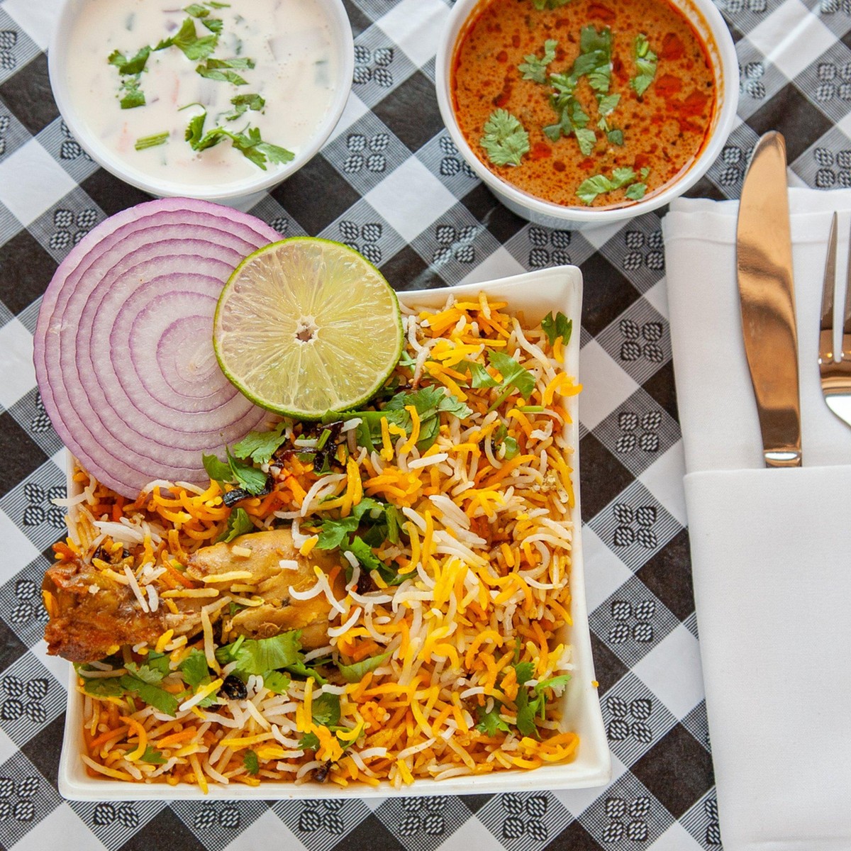 Hyderabadi Chicken Dum Biryani — The world-famous Hyderabadi bone-in chicken dum biryani, slow cooked with basmati rice and secret spices.